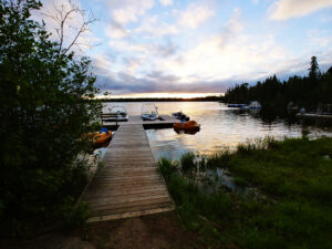 Dock with boats and a view of the lake behind them.